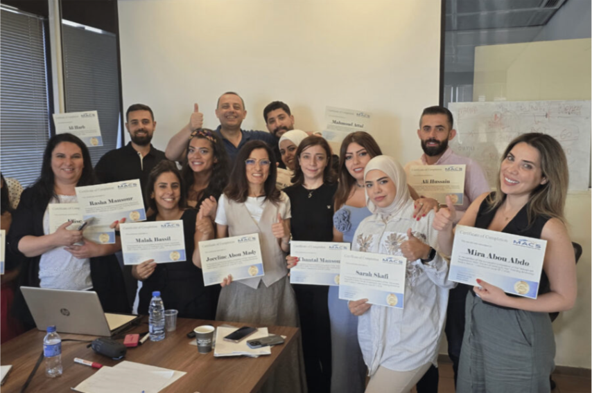 Healthcare professionals holding certificates after an L-Pharm training workshop